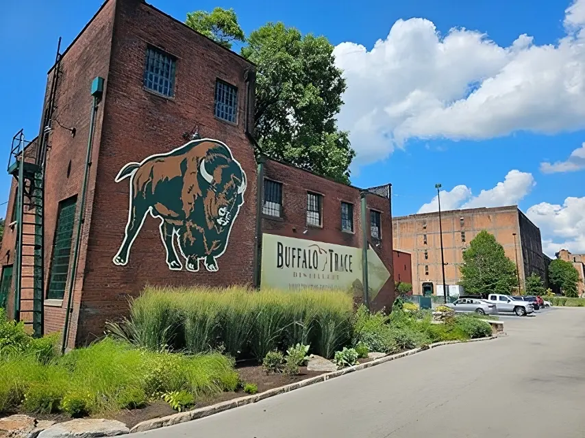 A brick building with a buffalo on it's side.