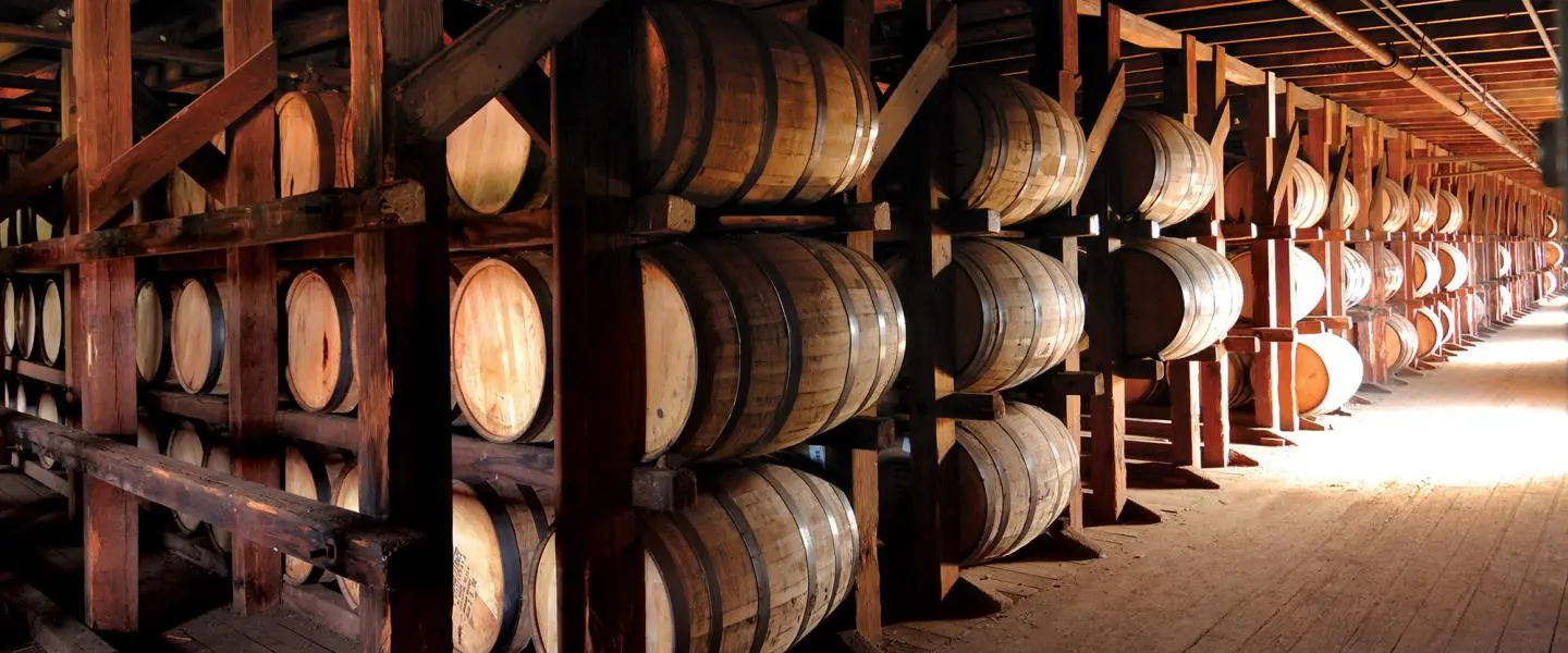 A bunch of barrels stacked up in the middle of a room.