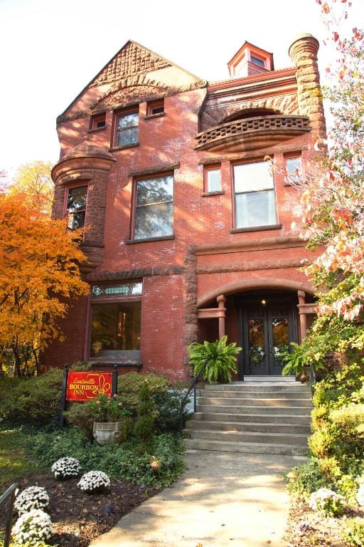 A large red brick house with a lot of windows.