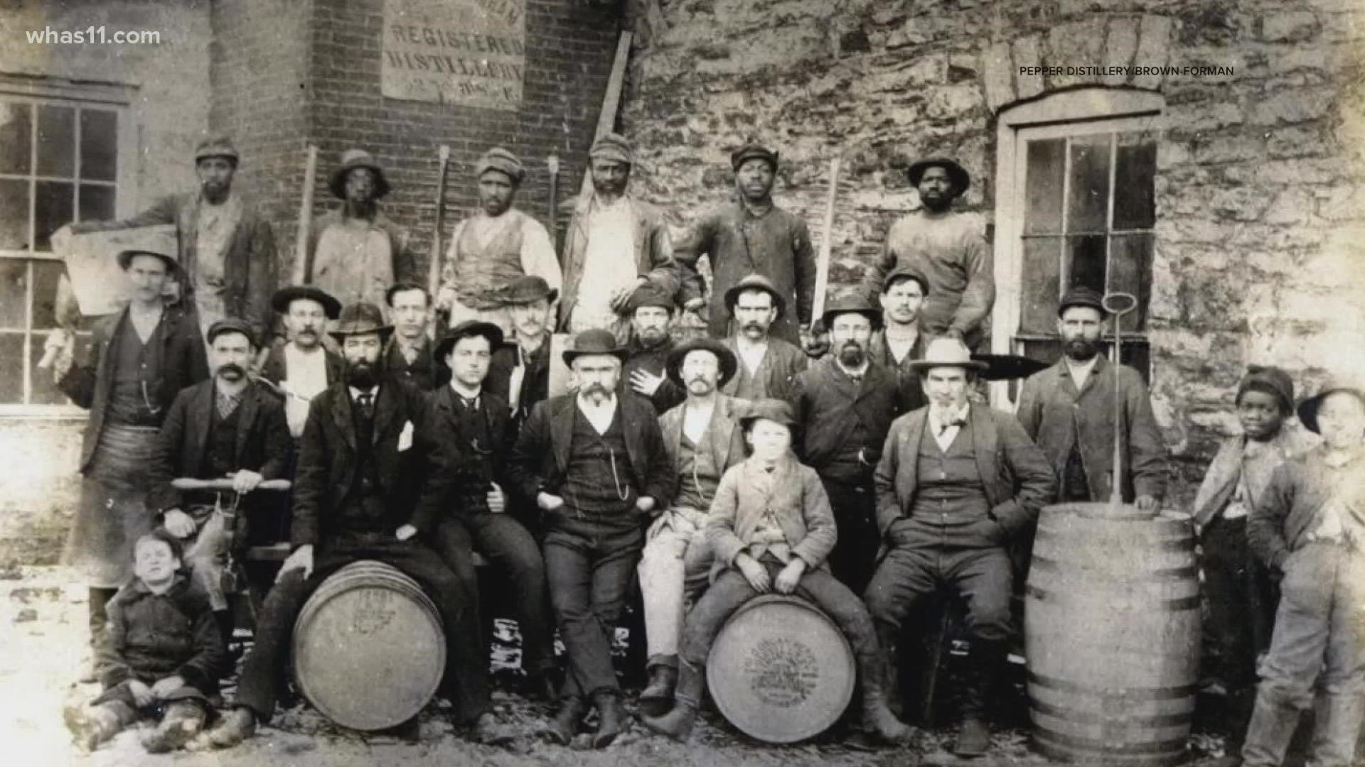 A group of men sitting around each other.