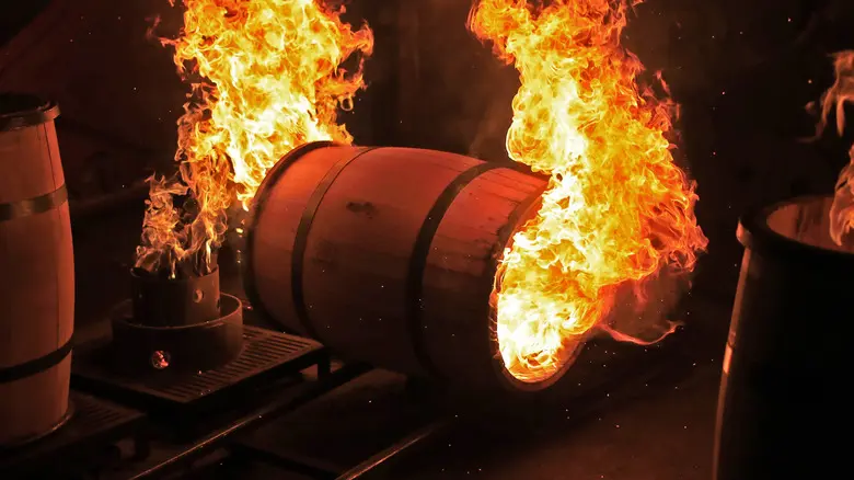 A barrel is burning in the middle of a fire.